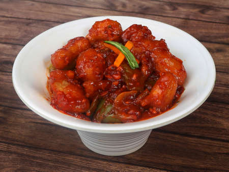 Veg Crispy is Batter Fried vegetables tossed with Chinese sauce tastes tangy. It's a popular Starters or appetizer in India. served over a rustic wooden table. selective focusの写真素材