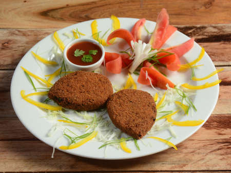 Vegetable cutlet, a delectable combination of mashed potatoes and vegetables. , served in a white...