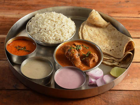 Mutton Thali from an indian cuisine, food platter consists of Mutton curry, lentils, jeera rice, curd and onions., selective focusの写真素材