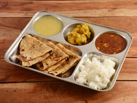 Veg Thali from an indian cuisine, food platter consists variety of veggies, lentils,rice,roti etc., selective focusの素材 [FY310173177635]