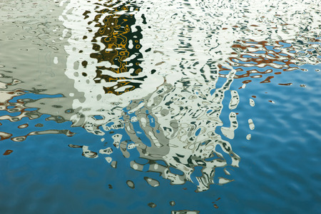 Colorful reflections on the sea water. Abstract background. Soft focus