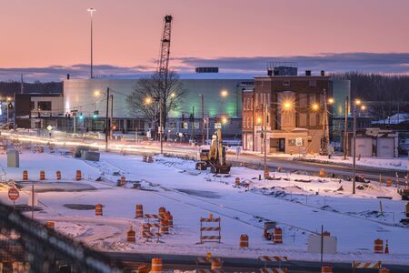 Utica, New York - Jan 20, 2020: Night View of a Work Zone in the Foreground and Adirondack Bank Center at the Utica Memorial Auditorium in the Background.のeditorial素材