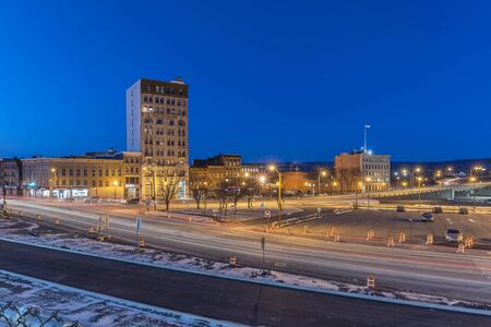 UTICA, NY - JAN 17, 2020: Wide Aerial Night View of Downtown Utica Streets and Cars Trail Lights with the Genesee Tower in the Background.のeditorial素材