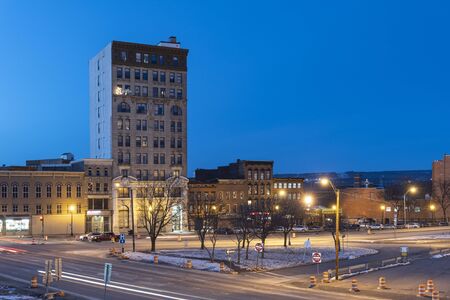 UTICA, NY - JAN 17, 2020: Closeup Aerial Night View of Downtown Utica Streets and Cars Trail Lights with the Genesee Tower in the Background.のeditorial素材