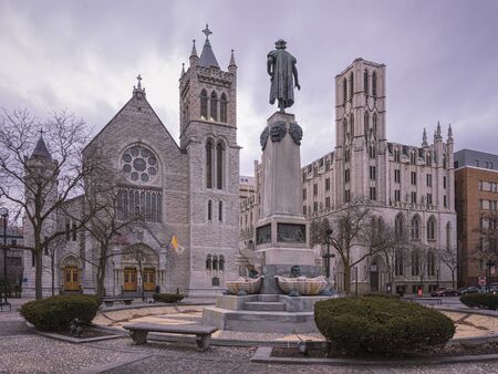 SYRACUSE, NEW YORK - JAN 14, 2020: Wide View of Columbus Circle in Foreground and Cathedral of...