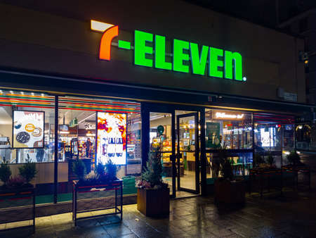 Stockholm, Sweden - December 19, 2021: Vertical Night View of 7-Eleven Convenience Store in Downtown...