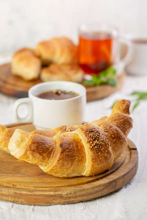 Chocolate croissant pastries with a cup of tea in the morningの写真素材