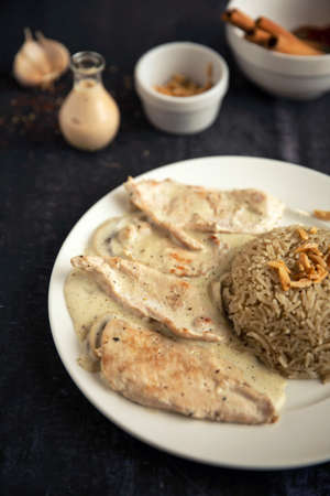 Chicken steaks with sauce, mushroom and riceの写真素材