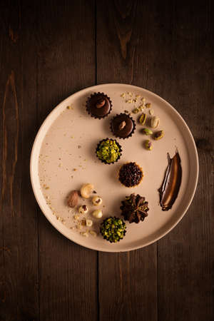 A brown dish that contains the most beautiful and delicious chocolatesの写真素材