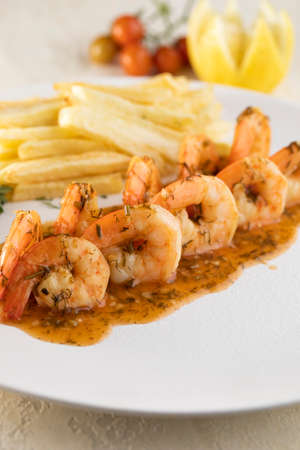 Fried, grilled and crispy shrimp with potato fingersの写真素材