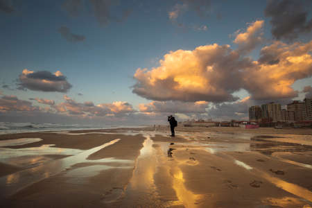 A lonely man in the desert waiting for God's mercy with rainの写真素材