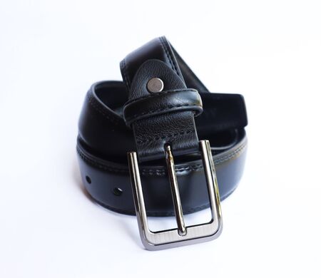 Black leather belt on isolated white backgroundの写真素材