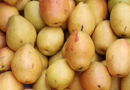 Fresh pears as background. Healthy pear fruit in a shop, top view