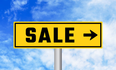 Sale road sign on blue sky backgroundの写真素材