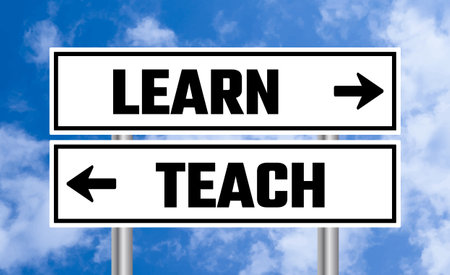 Learn or teach road sign on cloudy sky backgroundの写真素材