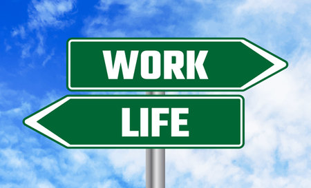 Work or life road sign on sky backgroundの写真素材