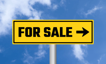 For sale road sign on cloudy sky backgroundの写真素材