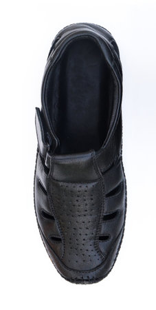 This shot features a detailed view of a black leather sandal shoe, highlighting the texture and design against a clean white backdrop.の写真素材
