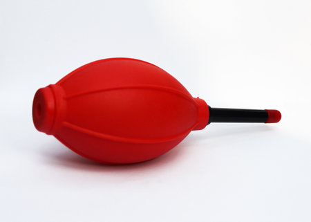 Red Color Hand Air Blower on white background. Rubber Air Blower Pump Dust Cleaner for Camera