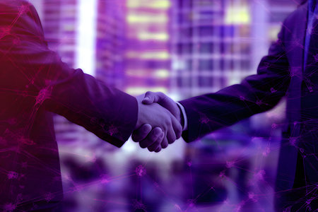 Handshake between business people on purple background with glowing lightsの素材