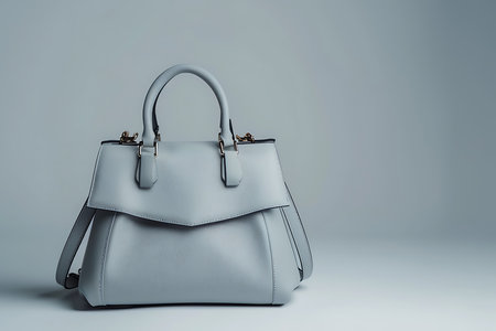 Luxury grey leather handbag on a grey backgroundの素材