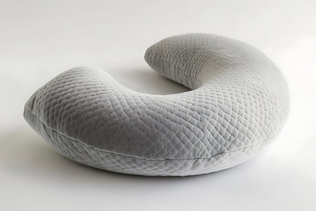 Crescent pillow with textured surface stands out against a clean backdrop. Modern cushion showcases simple form and subtle texture.の素材