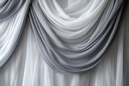 Swirling gray and white fabric creates an elegant and abstract backdrop, perfect for adding a touch of sophistication to interior designs and decorative projects.の素材