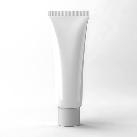 Close up shot displays a sleek white plastic tube for cosmetic or pharmaceutical products, with a plain cap. Ideal for showcasing packaging designs.の素材