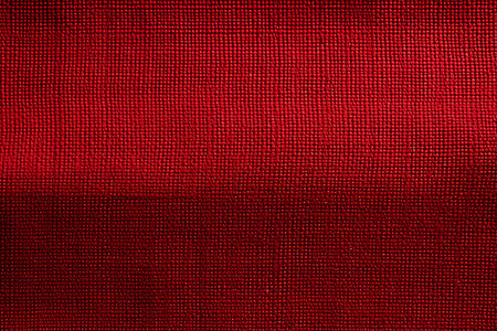 Presents a close-up view of a deep red textile. The textured surface captures light and shadows, creating depth and visual interest. Ideal for backgrounds or textured elements.の素材