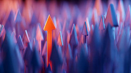An orange upward-pointing arrow stands out amongst a crowd of blurred blue arrows. The background is soft and dreamy, bathed in shades of orange, blue, and purple.の素材