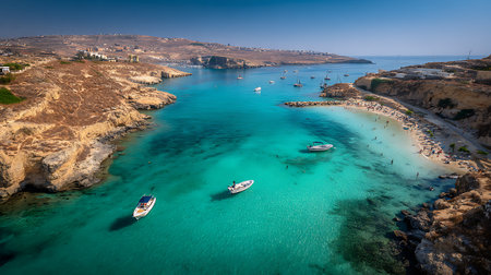 Breathtaking aerial shot of Comino Island's iconic Blue Lagoon in Malta. Features clear turquoise waters, boats, sandy beach, and scenic cliffs under a clear blue sky.の素材