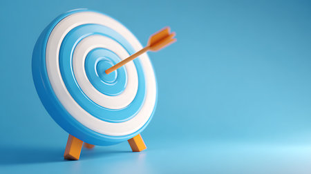 A vibrant, stylized target with blue and white concentric circles stands against a seamless blue background. An orange arrow strikes the bullseye at the center of the target.の素材