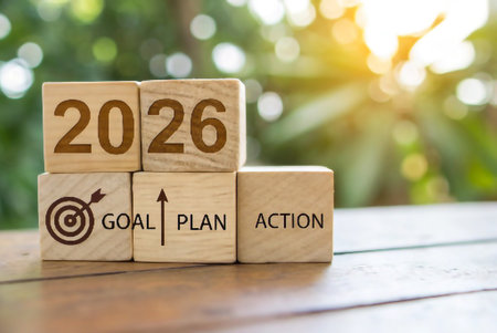 Wooden blocks spell out 2026 goal plan action with a target and arrow.の素材