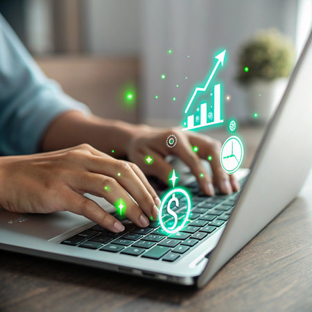 Close-up of hands typing on a laptop keyboard with digital financial growth icons and charts appearing.の素材