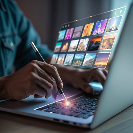 A person's hands are visible typing on a laptop, with the screen displaying a vibrant grid of movie thumbnails.の素材