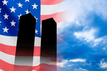 American flag and twin towers silhouette against dramatic skyの素材