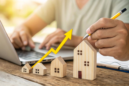 Rising real estate market growth with houses and upward arrowの素材