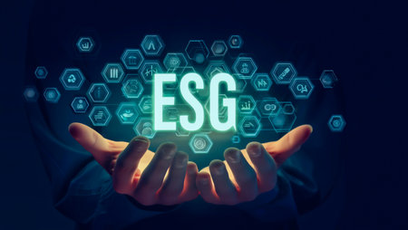 Hands holding glowing esg acronym surrounded by digital iconsの素材