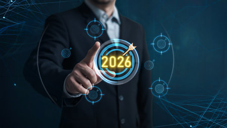 Businessman points to the year 2026 target on a futuristic digital interfaceの素材