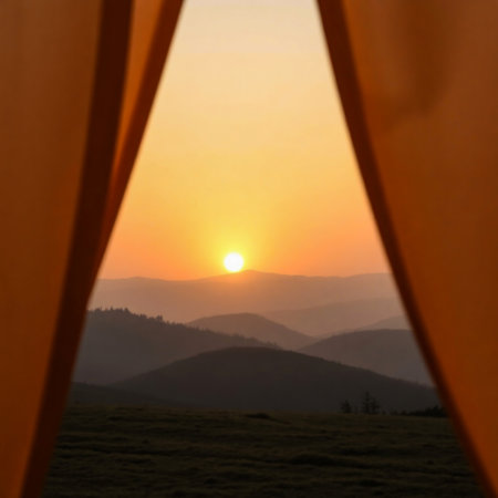View from the window of a tent on the mountains at sunset.の素材