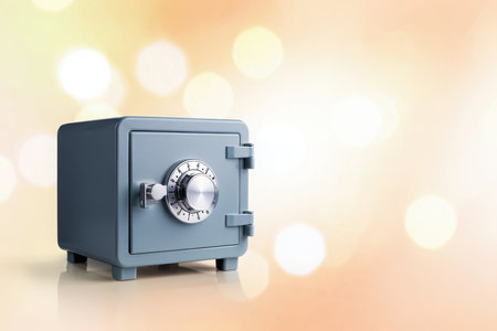 A small, gray metal safe with a silver combination lock sits on a surface.の素材