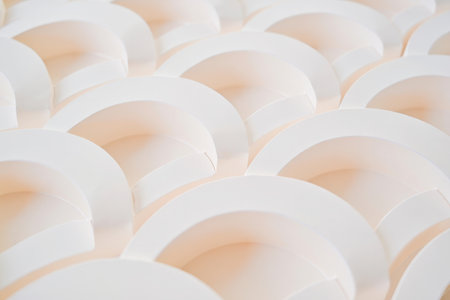 A close-up abstract view of overlapping soft pastel circles with subtle peach tones.の素材