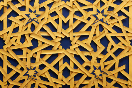 A detailed, repeating geometric pattern of yellow interlocking shapes against a deep blue backdrop.の素材