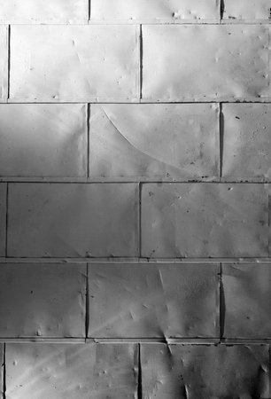 A dented, old metal wall for a backgroundの写真素材