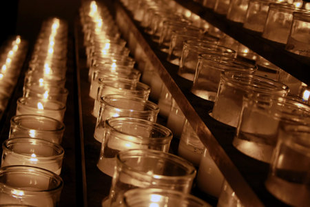 Rows of lit candles in a catholic churchのeditorial素材