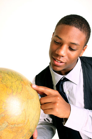 A smiling young man holding a globeの写真素材