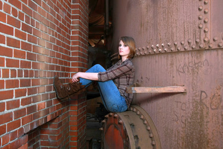 Young woman between a wall and a hard placeの写真素材