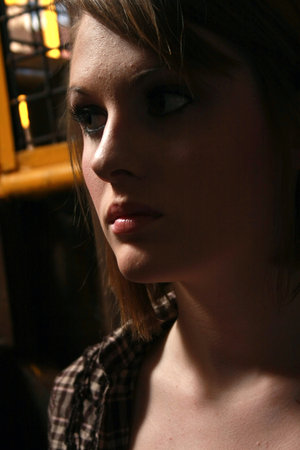 A young woman in a dark roomの写真素材
