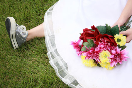 A bride wearing running shoes and a wedding gownの写真素材