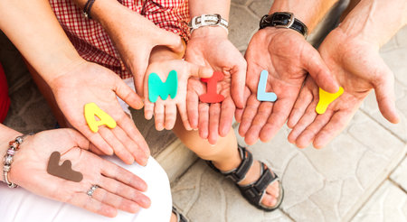 inscription family made of toy characters and laid out on the palmsの写真素材